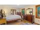 Bedroom featuring a four-poster bed, dresser, and large windows providing natural light at 708 Mills St, Raleigh, NC 27608