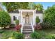 Charming single-story home featuring a covered front porch with beautiful landscaping at 708 Mills St, Raleigh, NC 27608