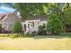 Inviting single-story home with manicured lawn and a quaint, covered front porch at 708 Mills St, Raleigh, NC 27608