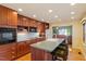 Cherry wood cabinets, built-in oven, cook top, recessed lights, and kitchen island at 708 Mills St, Raleigh, NC 27608