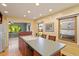 Bright kitchen island with sink, dark wood cabinets, and breakfast bar seating area at 708 Mills St, Raleigh, NC 27608