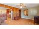 Comfortable living room featuring hardwood floors, wood paneling, and an open doorway leading to the adjacent kitchen at 708 Mills St, Raleigh, NC 27608