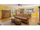 Sunny living room boasts hardwood floors, a brick fireplace, and large windows at 708 Mills St, Raleigh, NC 27608
