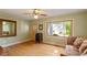 Bright living room with hardwood floors, a large window offering a view of the outdoors, and a decorative sofa at 708 Mills St, Raleigh, NC 27608