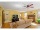 Open living room with ceiling fan, hardwood floors, and adjacent bathroom at 708 Mills St, Raleigh, NC 27608