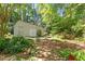 Backyard shed featuring double doors and adjacent mature landscaping at 708 Mills St, Raleigh, NC 27608