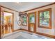 Bright sunroom with a bike on the wall, views of trees, and access to the dining room at 708 Mills St, Raleigh, NC 27608