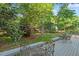 Backyard with furniture on deck, trees, and lawn at 7213 St Ledger Dr, Raleigh, NC 27613