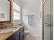 Well-lit bathroom features a glass shower, granite-topped vanity, and neutral color palette at 7213 St Ledger Dr, Raleigh, NC 27613