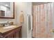 Bathroom with granite counter, wood vanity, sink, and shower at 7213 St Ledger Dr, Raleigh, NC 27613