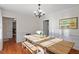 Warm and inviting dining room featuring wainscoting and a modern chandelier at 7213 St Ledger Dr, Raleigh, NC 27613