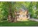 Charming two-story brick home with mature trees and lush green lawn at 7213 St Ledger Dr, Raleigh, NC 27613
