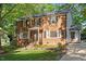 Charming two-story brick home with mature trees and professionally landscaped front yard at 7213 St Ledger Dr, Raleigh, NC 27613