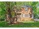 Charming two-story brick home with lush lawn and mature trees at 7213 St Ledger Dr, Raleigh, NC 27613