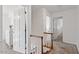 Hallway with carpeted floors, white doors, and wood railing at 7213 St Ledger Dr, Raleigh, NC 27613