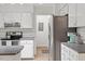 Kitchen with white cabinets, stainless steel appliances, and tile flooring at 7213 St Ledger Dr, Raleigh, NC 27613
