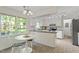 Cozy kitchen featuring white cabinetry, natural light, and a breakfast nook at 7213 St Ledger Dr, Raleigh, NC 27613