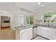Bright kitchen with white cabinets, stainless steel appliances, and eat-in area at 7213 St Ledger Dr, Raleigh, NC 27613