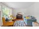 Cozy living room with hardwood floors, large windows, and comfortable seating at 7213 St Ledger Dr, Raleigh, NC 27613