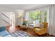 Bright living room featuring hardwood floors, large windows, and natural light at 7213 St Ledger Dr, Raleigh, NC 27613