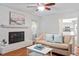 Cozy living room with fireplace, hardwood floors, and natural light at 7213 St Ledger Dr, Raleigh, NC 27613