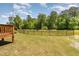 Private backyard with a wooden deck and lush green surroundings, ideal for outdoor activities at 7508 Channery Way, Raleigh, NC 27616