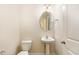 Charming half bath featuring a pedestal sink and classic fixtures, conveniently located near the living area at 7508 Channery Way, Raleigh, NC 27616
