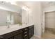Bright bathroom with double vanity, walk-in shower, and a well-organized walk-in closet at 7508 Channery Way, Raleigh, NC 27616