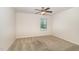Cozy bedroom with neutral carpet, a ceiling fan, and a bright window offers a comfortable space at 7508 Channery Way, Raleigh, NC 27616