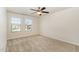 Bright bedroom featuring neutral carpet, ceiling fan, and double windows offering natural light at 7508 Channery Way, Raleigh, NC 27616