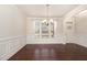 Bright dining room features large windows, elegant trim, and hardwood floors near the entry at 7508 Channery Way, Raleigh, NC 27616