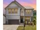 Charming two-story home featuring a cozy front porch, complemented by a well-maintained lawn at 7508 Channery Way, Raleigh, NC 27616