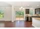 Kitchen featuring granite countertops, stainless appliances, and access to an outdoor deck at 7508 Channery Way, Raleigh, NC 27616