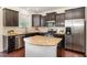 Modern kitchen featuring granite countertops, stainless steel appliances, and a center island at 7508 Channery Way, Raleigh, NC 27616