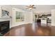 Inviting living room with fireplace, open to the kitchen, and hardwood floors for a seamless living space at 7508 Channery Way, Raleigh, NC 27616
