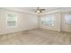 Spacious bedroom with large windows, a ceiling fan, and plush carpeting for a comfortable retreat at 7508 Channery Way, Raleigh, NC 27616