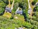 Aerial view of a landscaped home featuring a backyard and surrounding greenery at 76 Bergeson Ct, Fuquay Varina, NC 27526