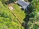Beautiful aerial view showcasing a home with a well-maintained lawn, wooden fence, and cozy firepit area at 76 Bergeson Ct, Fuquay Varina, NC 27526