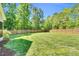 Well-maintained backyard featuring a lush lawn and a sturdy wooden fence for privacy and security at 76 Bergeson Ct, Fuquay Varina, NC 27526