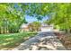 Charming home with a long driveway, a two-car garage, mature landscaping, and a covered front porch at 76 Bergeson Ct, Fuquay Varina, NC 27526