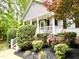 Inviting front porch with black shutters surrounded by lush landscaping at 76 Bergeson Ct, Fuquay Varina, NC 27526