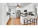 Bright kitchen with white cabinets, stainless steel appliances, and a breakfast bar at 76 Bergeson Ct, Fuquay Varina, NC 27526