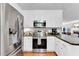 Well-lit kitchen featuring stainless steel appliances and dark countertops at 76 Bergeson Ct, Fuquay Varina, NC 27526