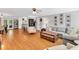 Open-concept living room with hardwood floors connecting to a kitchen with bar seating at 76 Bergeson Ct, Fuquay Varina, NC 27526