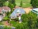 Expansive aerial view of an estate home showing professional landscaping and a view of the golf course at 77 Ruffed Grouse, Chapel Hill, NC 27517