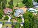 Overhead view of a home surrounded by manicured lawns, lush trees, and golf course creating scenic landscapes at 77 Ruffed Grouse, Chapel Hill, NC 27517