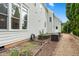 Backyard featuring a garden, gravel pathway, and the home's exterior, perfect for relaxation at 77 Ruffed Grouse, Chapel Hill, NC 27517