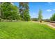 Expansive backyard with lush green lawn and mature trees offering a serene and private outdoor space at 77 Ruffed Grouse, Chapel Hill, NC 27517