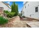 Private backyard with stone patio, garden bed, and mature landscaping, ideal for outdoor enjoyment at 77 Ruffed Grouse, Chapel Hill, NC 27517