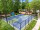Outdoor basketball court with well-maintained surface and surrounding trees, in community at 77 Ruffed Grouse, Chapel Hill, NC 27517